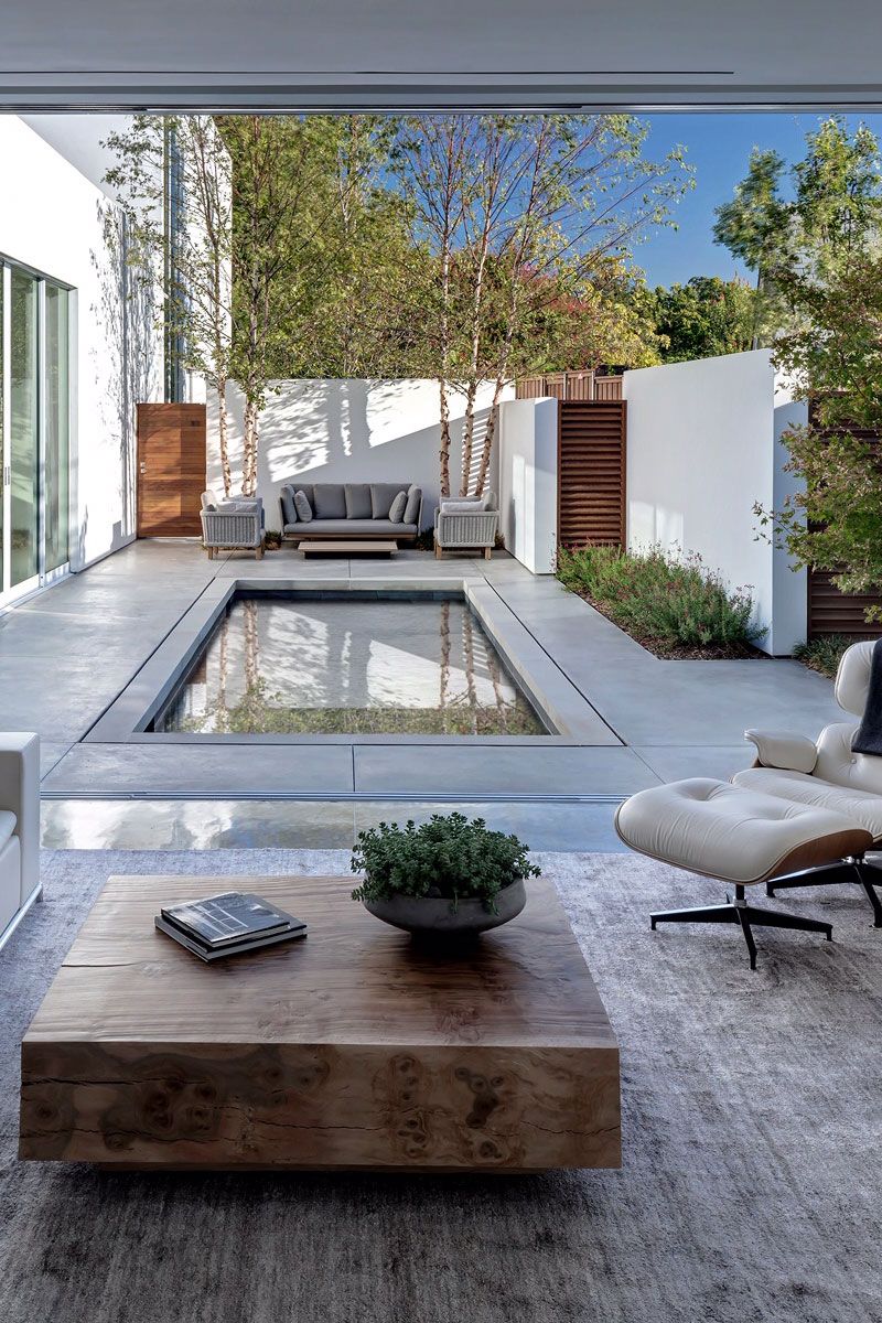 Small backyard with simple pool and outdoor living room