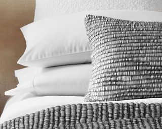 Best pillows grey and stacked on neutral bedding in neutral bedroom