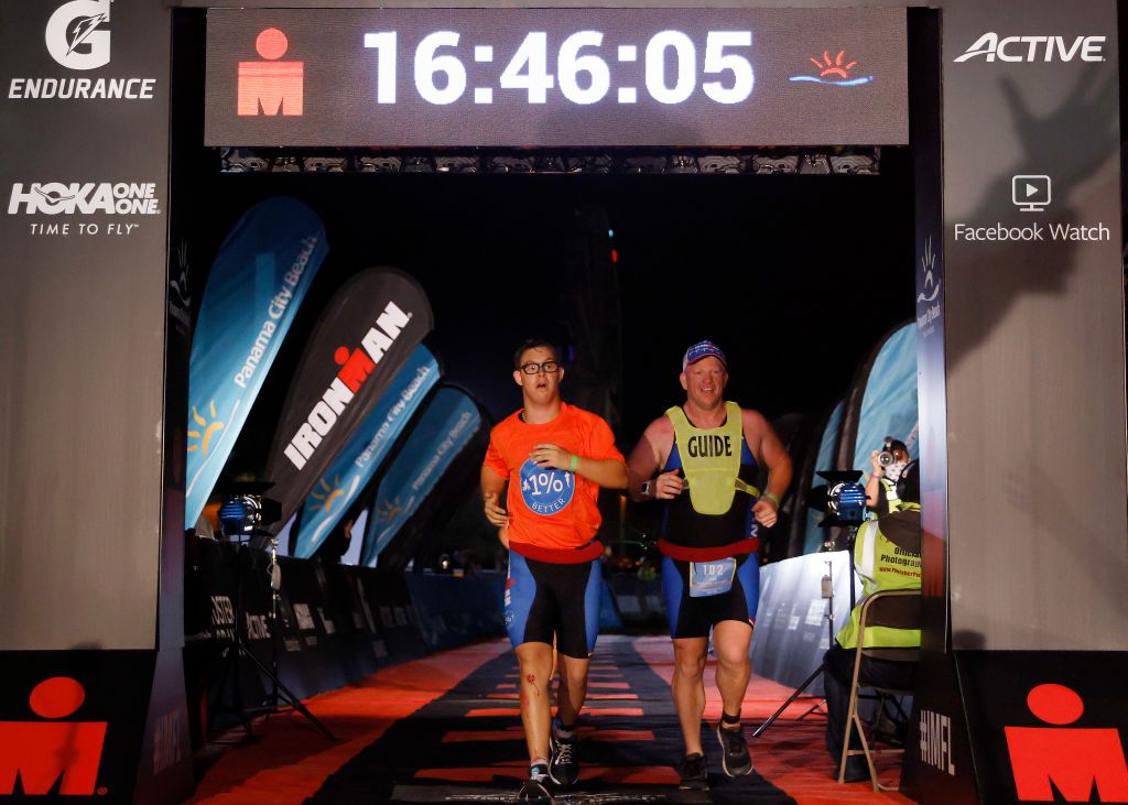 Chris Nikic crosses the finish line at IRONMAN Florida.