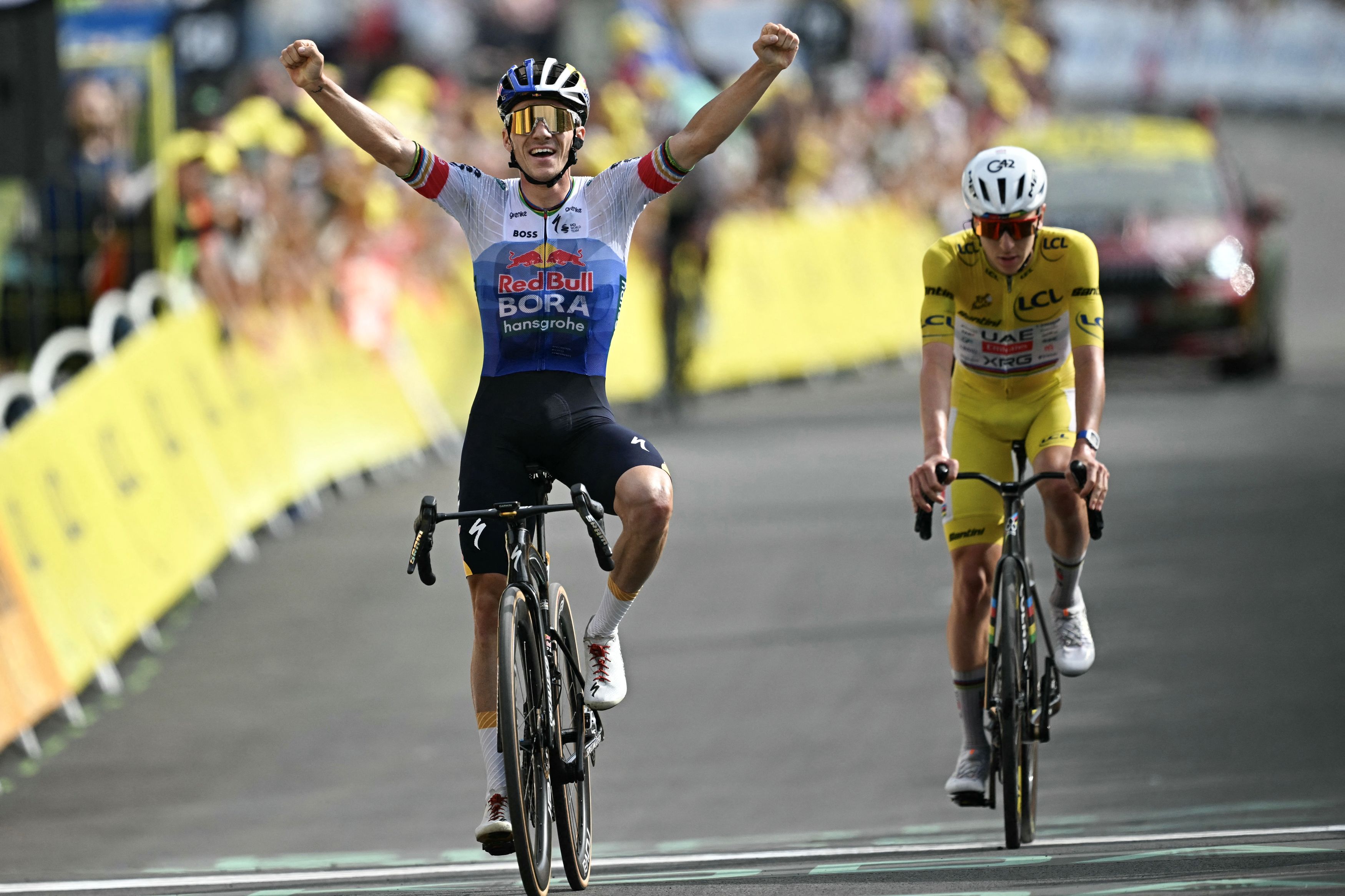 Red Bull - BORA - hansgrohe team's Belgian rider Remco Evenepoel cycles to the finish line to win ahead of UAE Team Emirates - XRG's Slovenian rider Tadej Pogacar (R) during the 15th stage of the 113th edition of the Tour de France cycling race, 183,9 km between Champagnole and Plateau de Solaison in the Jura mountains, on July 19, 2026. (Photo by Loic VENANCE / AFP via Getty Images)