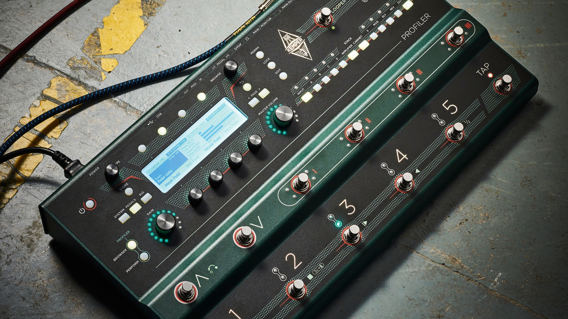 A Kemper Profiler Stage multi-effects pedal on a concrete floor