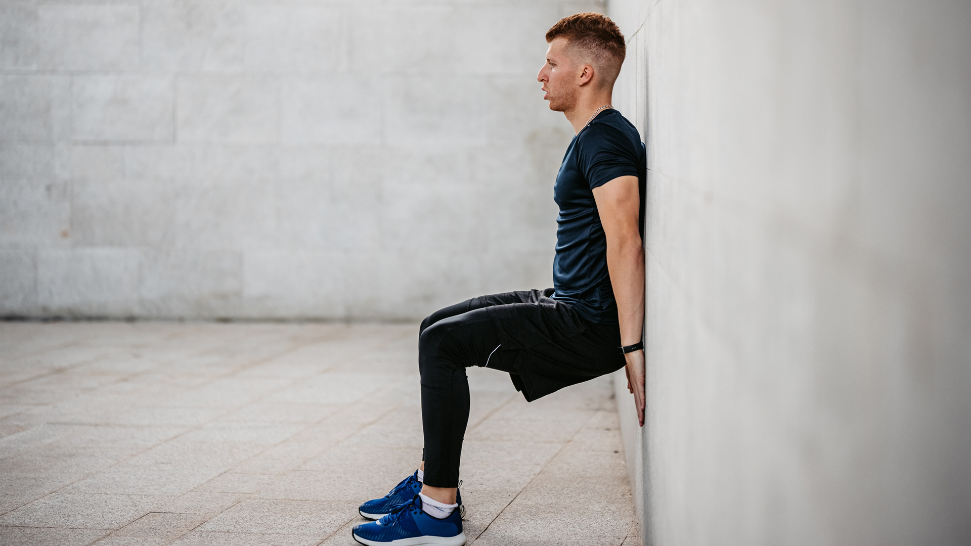 man performing a wall sit