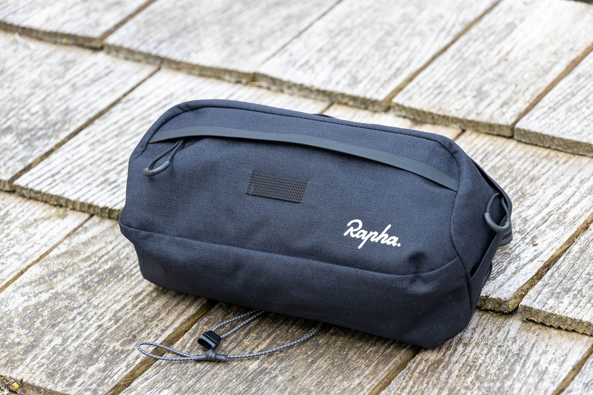 Rapha Explore Bar Bag resting on wooden background