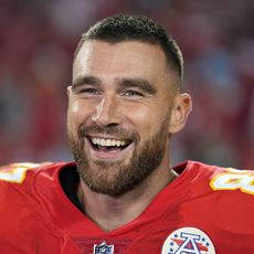 Travis Kelce smiles at a Kansas City Chiefs game