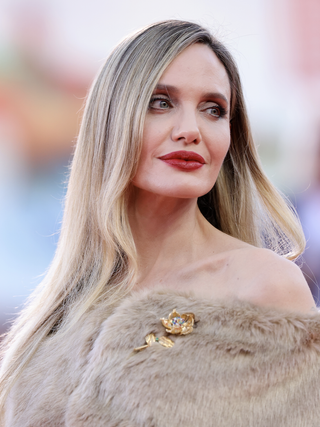 angelina jolie wears a fur sole and brooch at the 2024 venice film festival