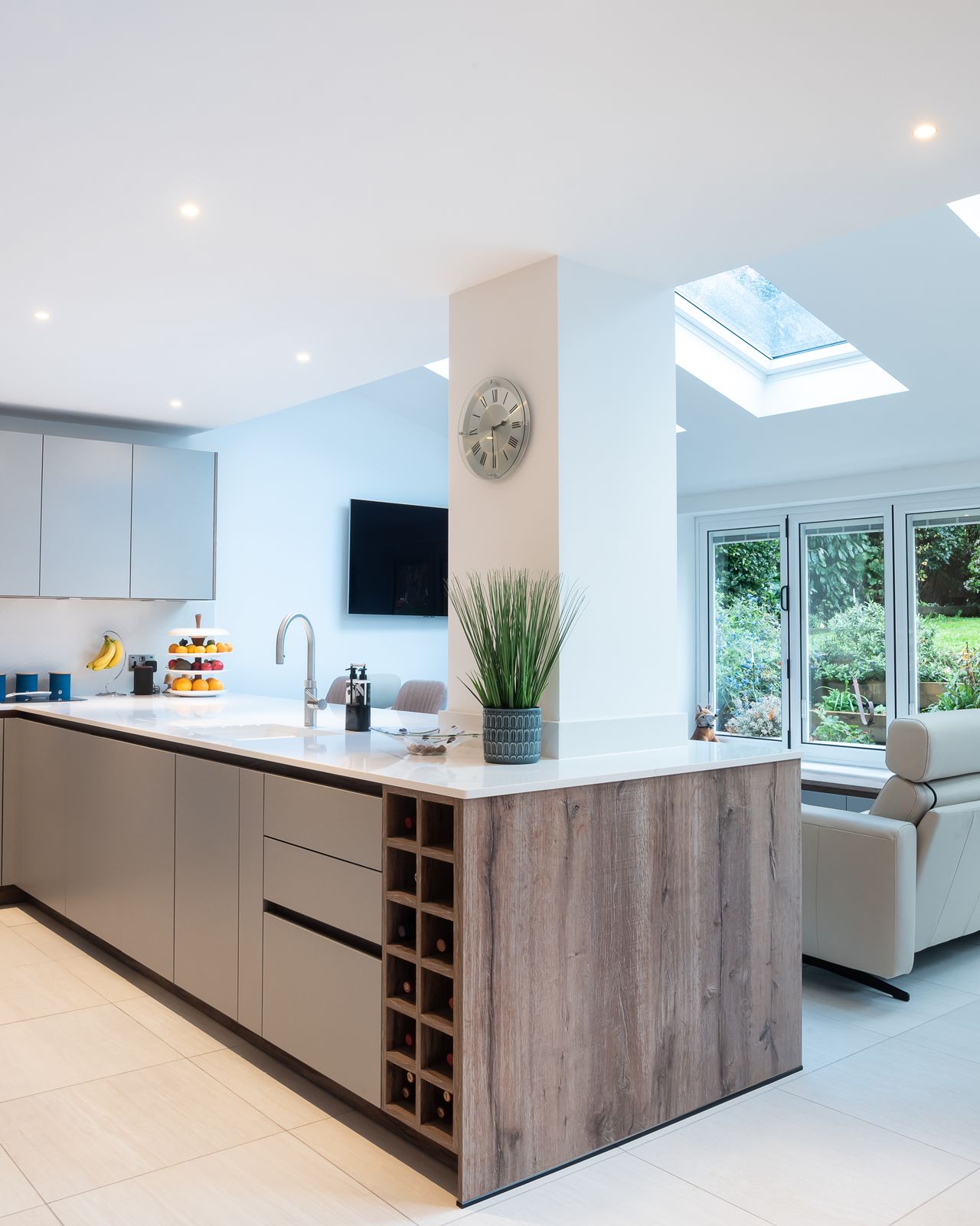 A kitchen with a peninsula that offers storage, cleaning and a place to chop veggies