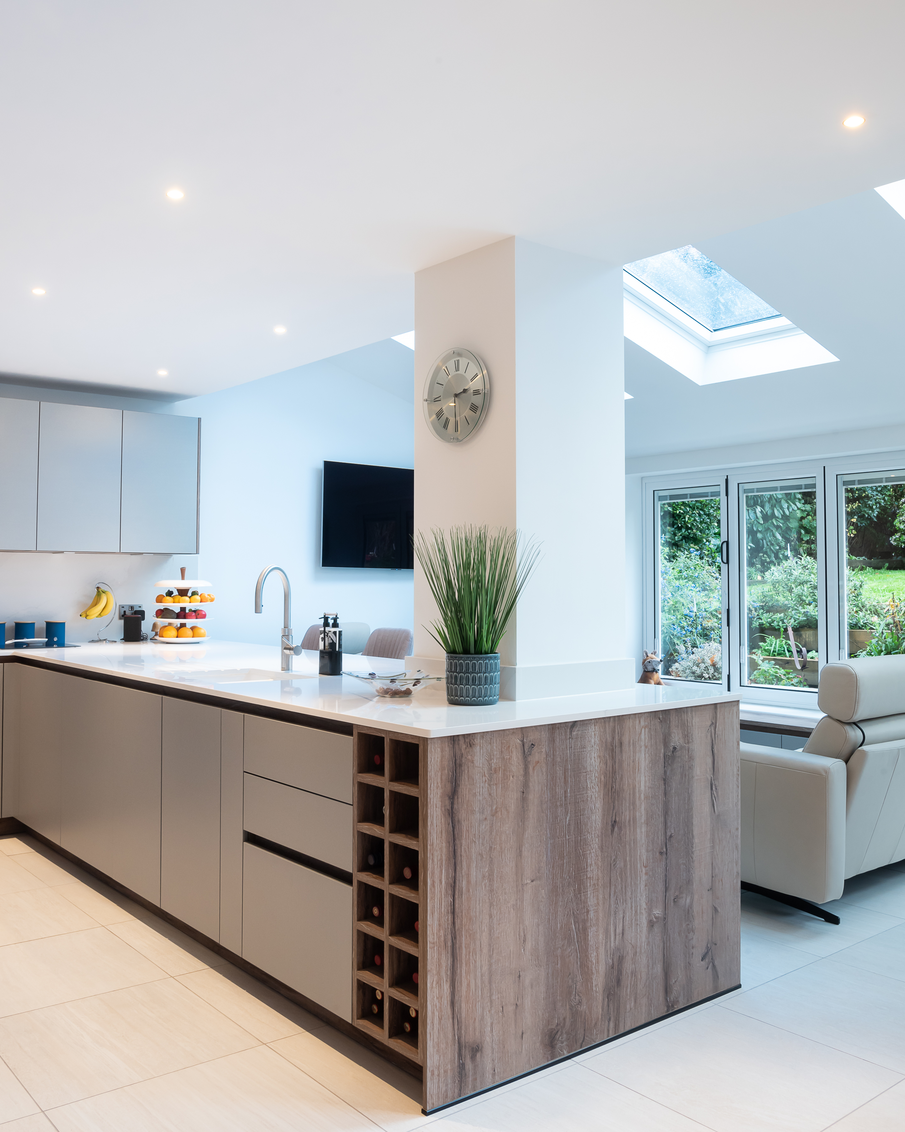 A kitchen with a peninsula that offers storage, cleaning and a place to chop veggies 