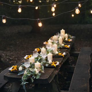 garden decor ideas: bench with candles and festoon lights