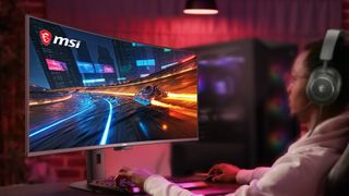 a gamer sits at a nice gaming monitor