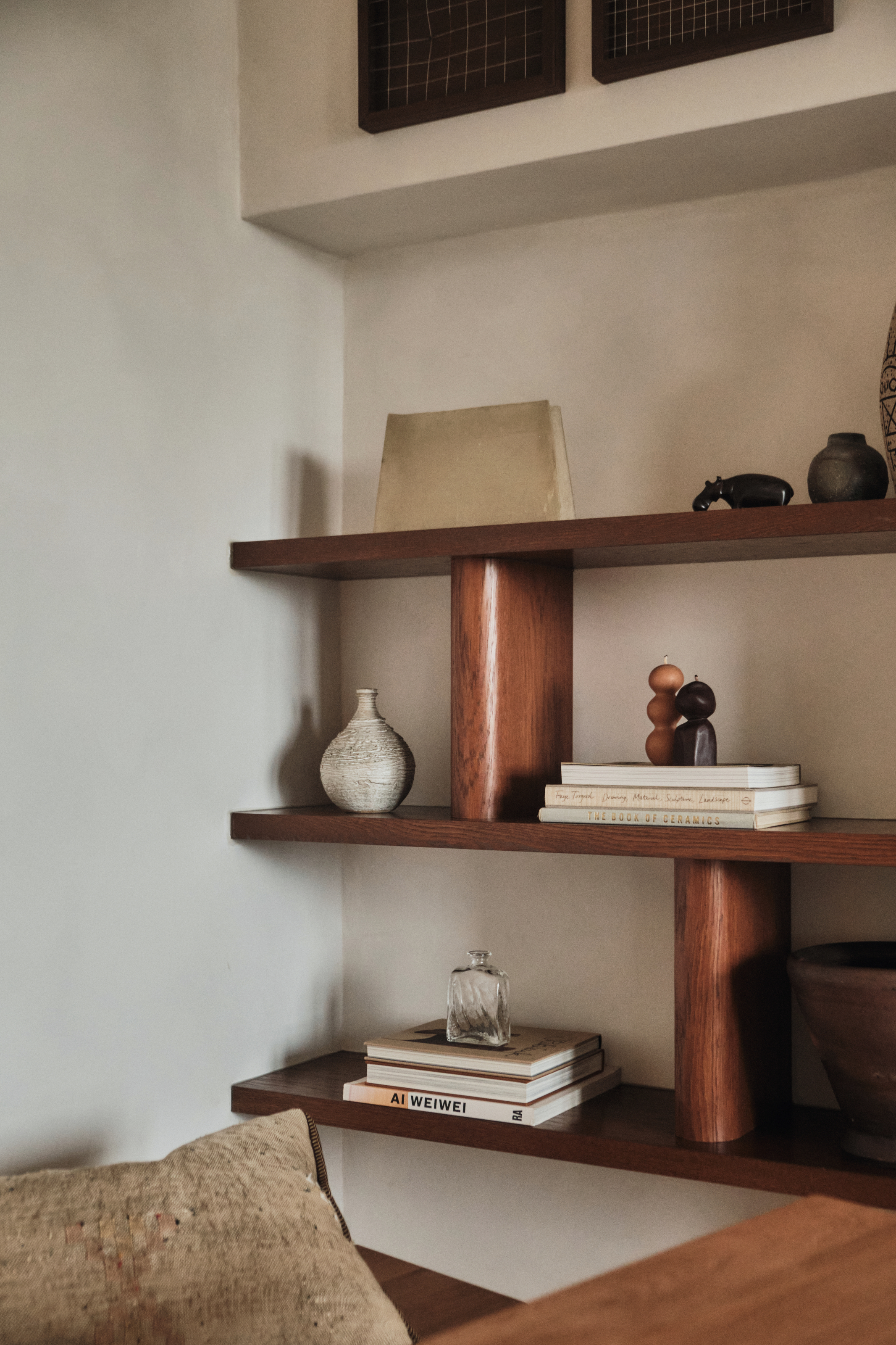 Bespoke chunky oak shelving in the corner of a living room