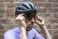 Smith Ultralite sunglasses being placed on the face of Aaron Borrill