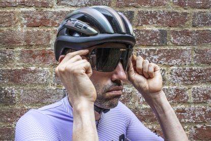 Smith Ultralite sunglasses being placed on the face of Aaron Borrill