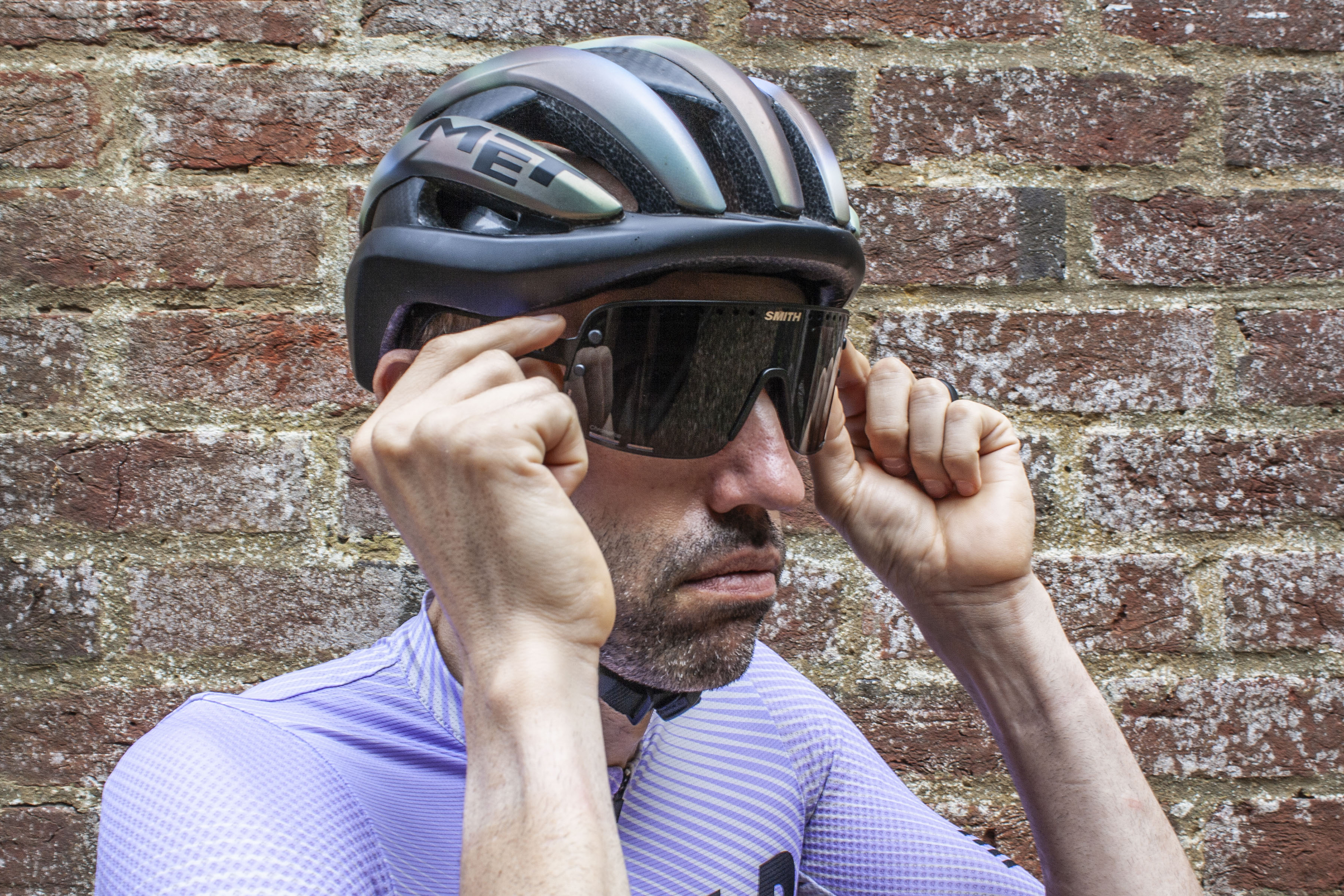 Smith Ultralite sunglasses being placed on the face of Aaron Borrill