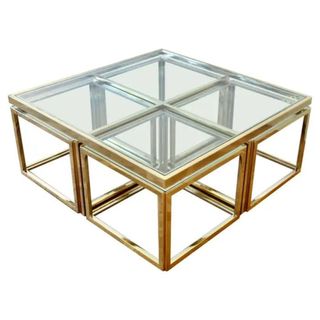 A glass coffee table with gold details