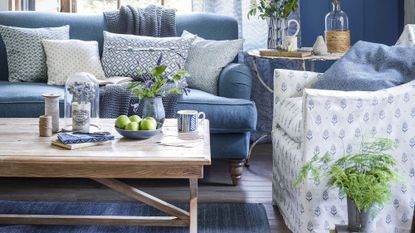 living room with wooden coffee table and blue sofa