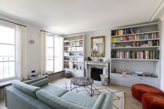 Paris apartment with large windows and blue sofa