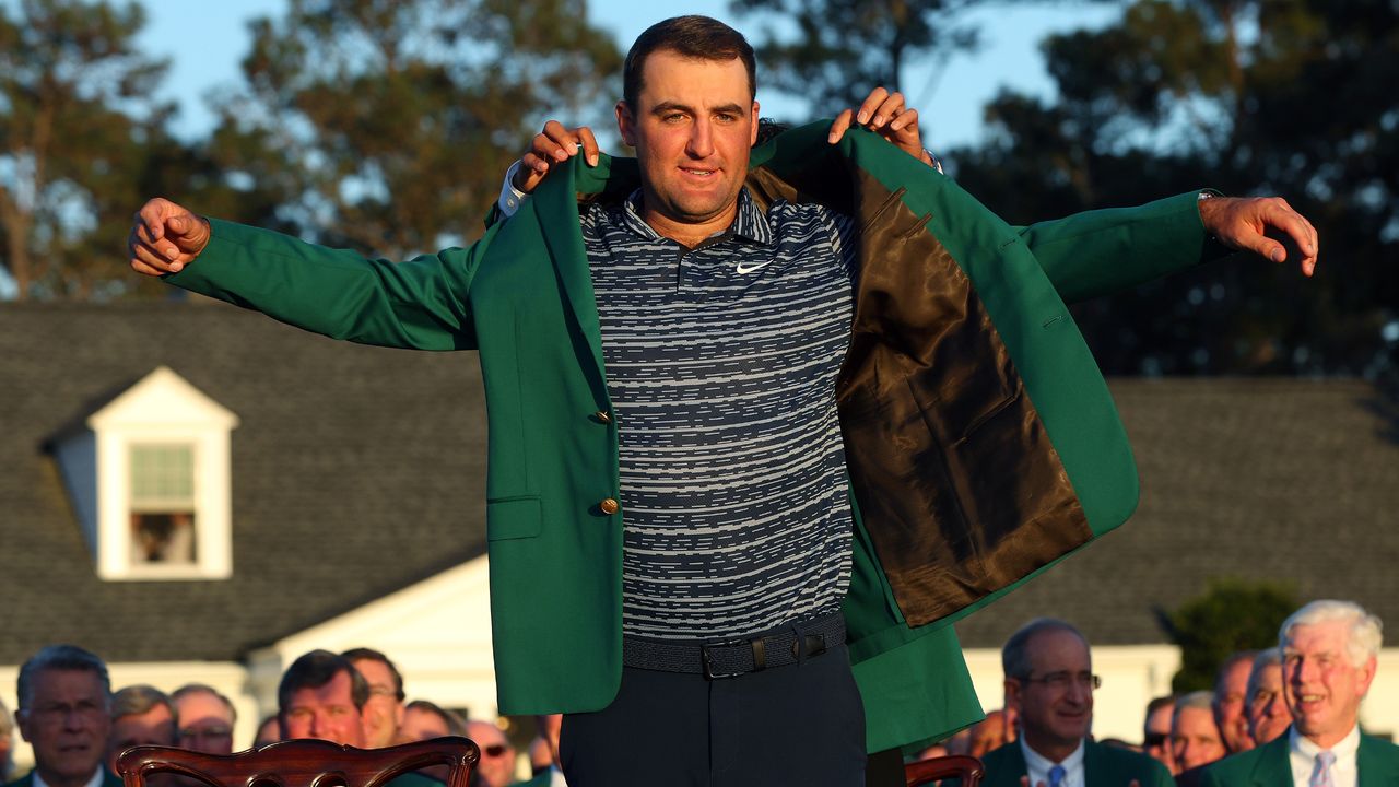 Scottie Scheffler receives the Green Jacket from Hideki Matsuyama after winning the 2022 Masters at Augusta National