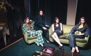 Models wearing pieces from burgeoning womenswear line sitting on velvet couches