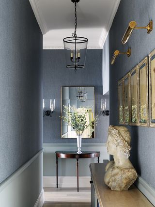 Blue hallway with large mirror and traditional panelling