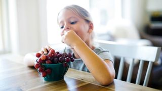Child eating grapes