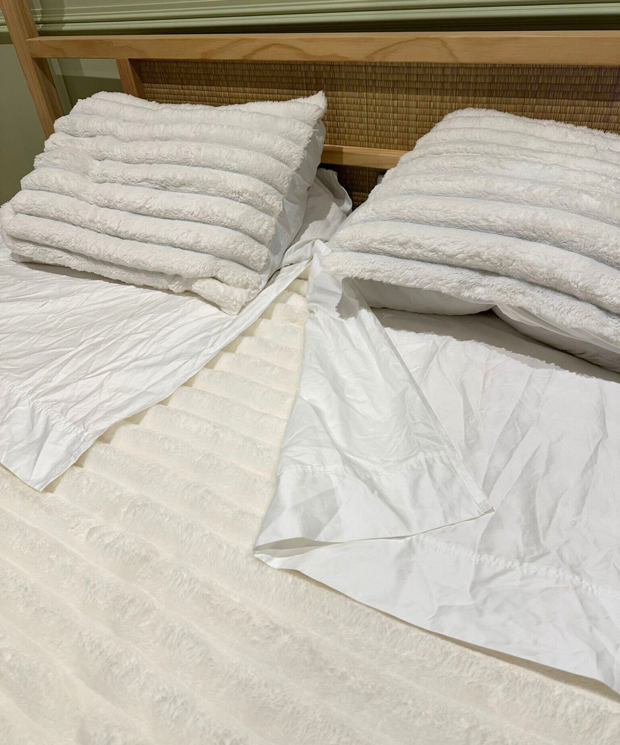 The Dreamwings bed sheets shown on my Japan-style bed with fluffy white bedding.