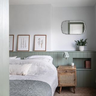 bedroom with white and grey wall bed frames at wall and bedside table