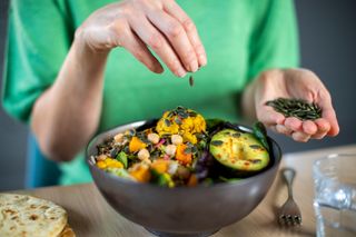 Gut health hacks: womans hands and a salad