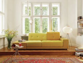 living room with yellow sofa and white scheme by nest