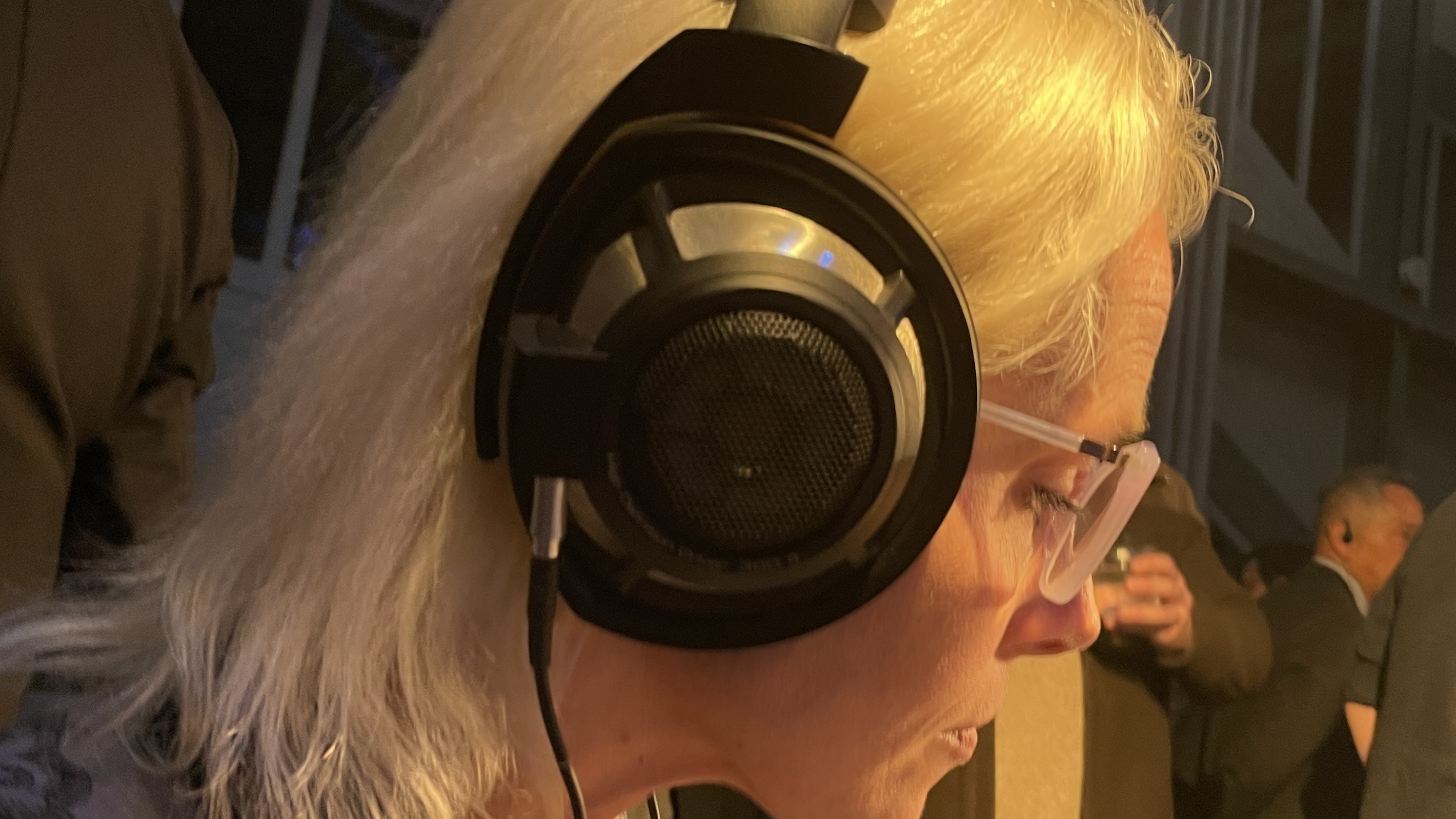 The formidable iFi iDSD Phantom in Tower Bridge, London, used with headphones and illuminating the front panel 