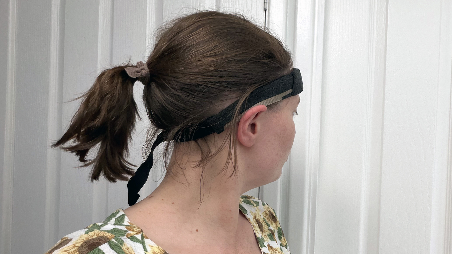 An image of the back of the head of sleep tester Ruth Jones, wearing the Muse S Athena