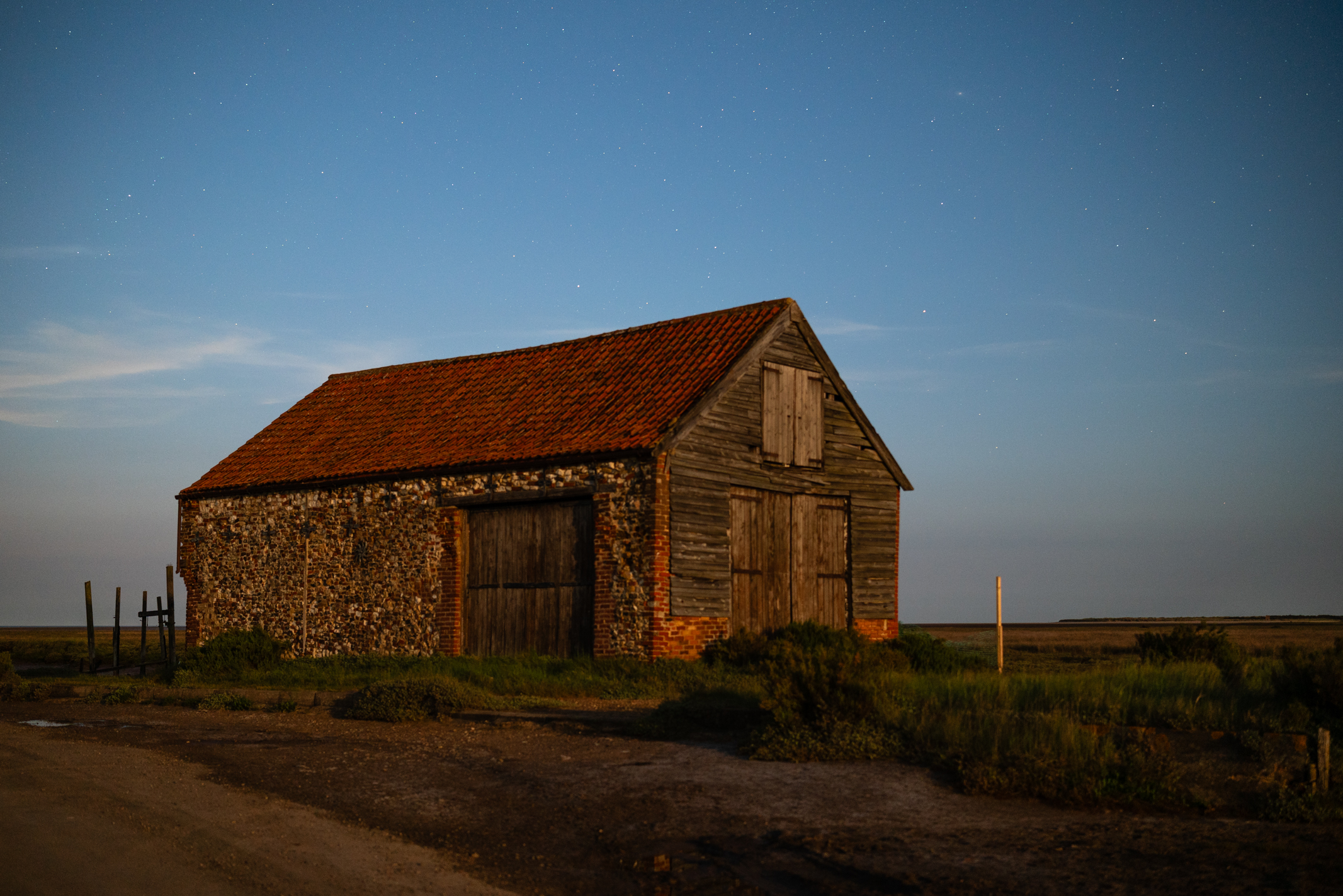 Photo of a coastal storage barn taken with the Viltrox AF 27mm f/ 1.2 Pro under the June 2025 strawberry moon