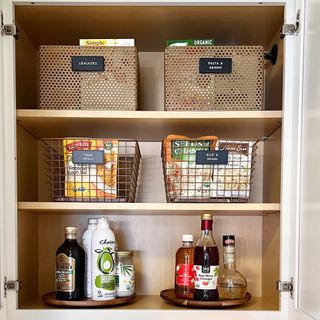 Metal baskets and rotating trays with condiments across three pantry shelves