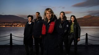 Annika season 2: A composite shot of the cast of Annika's second season, standing in front of a waterfront view. From left to right: Katie Leung as DC Blair Ferguson, Ukweli Roach as DS Tyrone Clarke, Nicola Walker as DI Annika Strandhed, Jamie Sives as DS Michael McAndrews, Varada Sethu as DC Harper