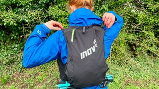 Woman wearing inov-8 Ultrapac Pro 2-in-1 running backpack