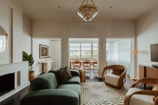 a living room with art deco furniture, rug, styling and lighting