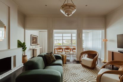 a living room with art deco furniture, rug, styling and lighting