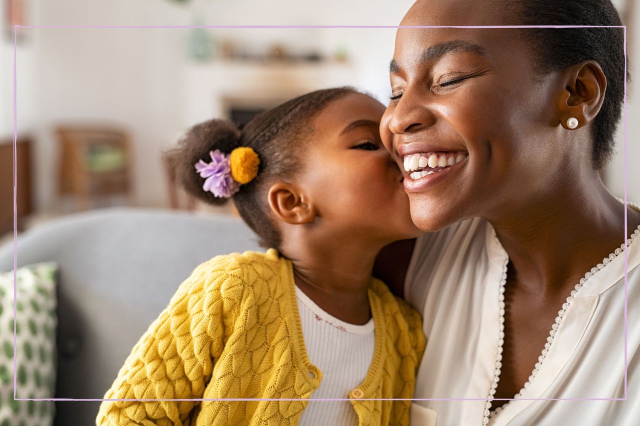 A young girl kissing her mother on the cheek