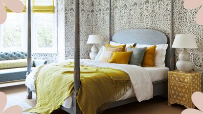 Bedroom with four poster bed and ornate damask wallpaper on walls with matching nightstands to show how to arrange your bedroom using the art of Feng Shui