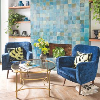 tiled fireplace in a living space with blue green zellige tiles on the chimney breast
