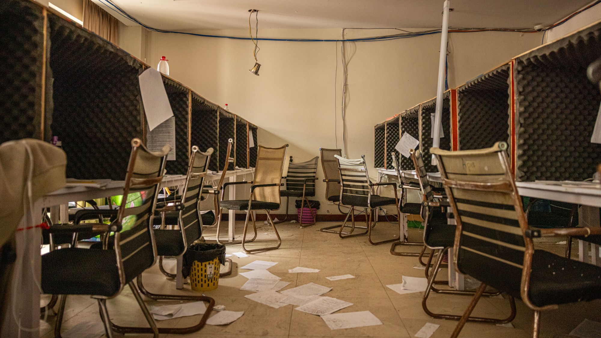 Abandoned computers and chairs inside a scam centre on the site of a former casino on the Cambodian border with Thailand