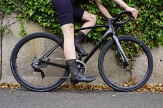 Female cyclist using the heel method to adjust her bike saddle height