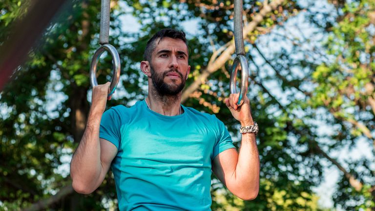 Man using gym rings to work out