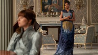 (L to R) Claudia Jessie as Eloise Bridgerton, Simone Ashley as Kate Sharma wearing a deep blue dress.