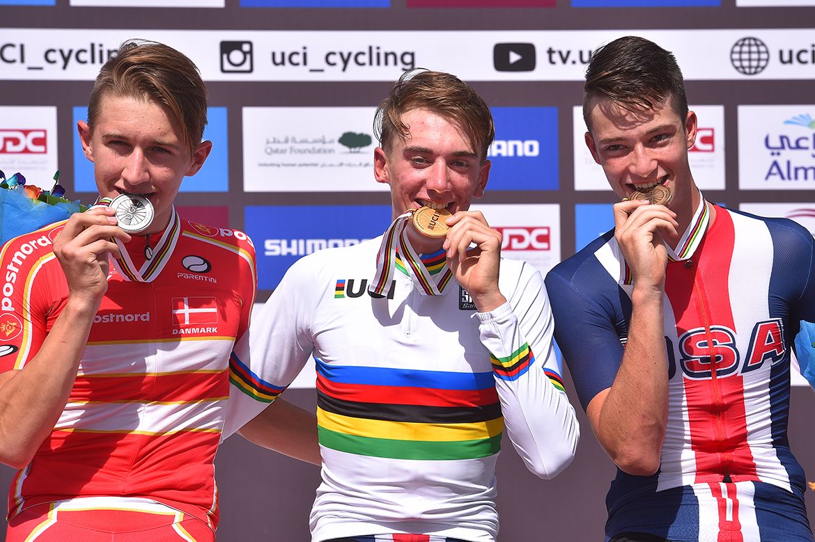Brandon McNulty alongside Bjerg and Garrison on the podium