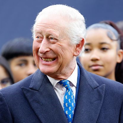 LONDON, UNITED KINGDOM - FEBRUARY 12: (EMBARGOED FOR PUBLICATION IN UK NEWSPAPERS UNTIL 24 HOURS AFTER CREATE DATE AND TIME) King Charles III attends a demonstration by young people involved in The Huddle Project during a visit to Tottenham Hotspur Stadium on February 12, 2025 in London, England. The Huddle Project is a dual sport programme (launched in 2023 by Tottenham Hotspur Football Club, the National Football League (NFL) and Nike) for boys and girls aged 11-18 which increases access to free football and NFL Flag. (Photo by Max Mumby/Indigo/Getty Images)