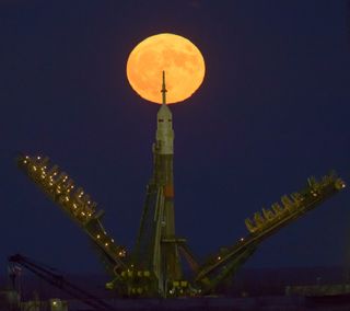 November's supermoon is seen rising behind the Soyuz rocket at the Baikonur Cosmodrome launch pad in Kazakhstan, Monday (Nov. 14).