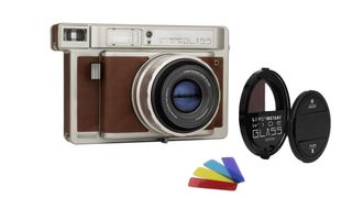 Lomo Instant Wide Glass instant camera with color gels and lens mod accessories on white background