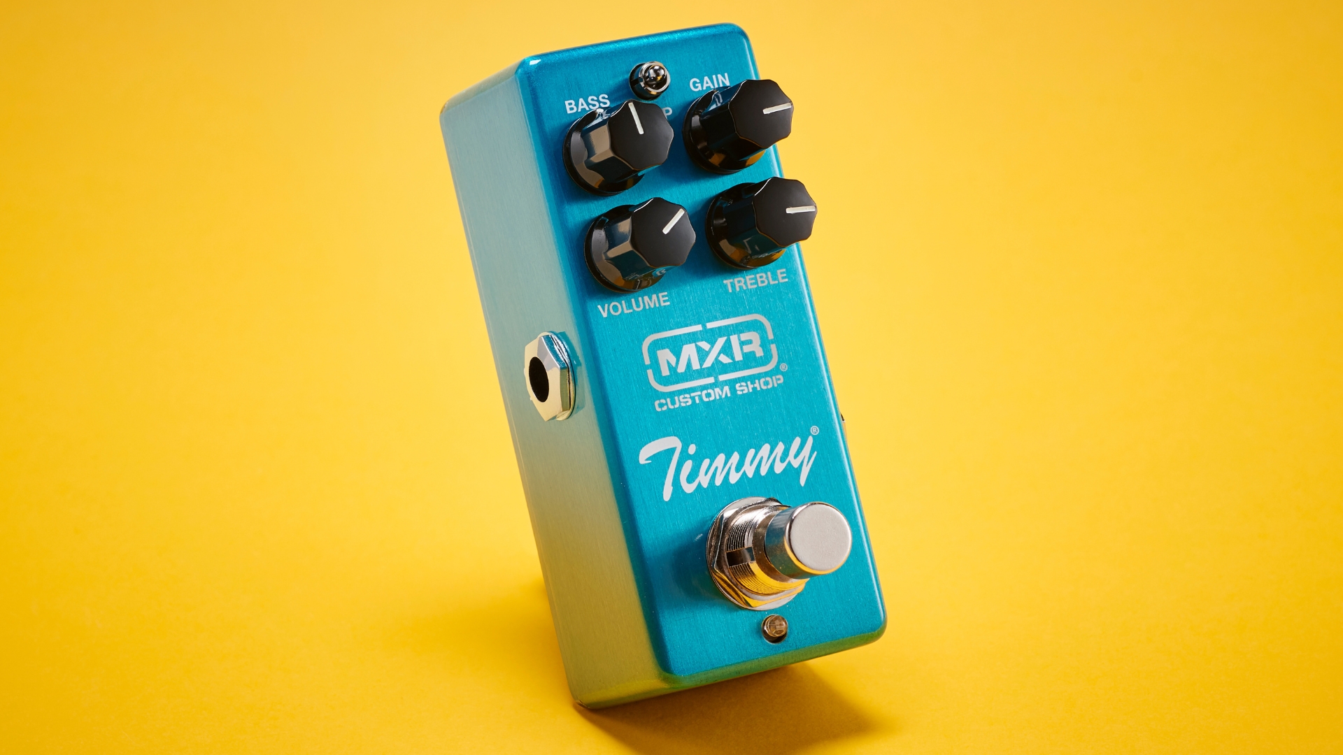 An MXR Timmy overdrive pedal on a yellow backdrop