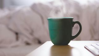 steaming mug on bedside table