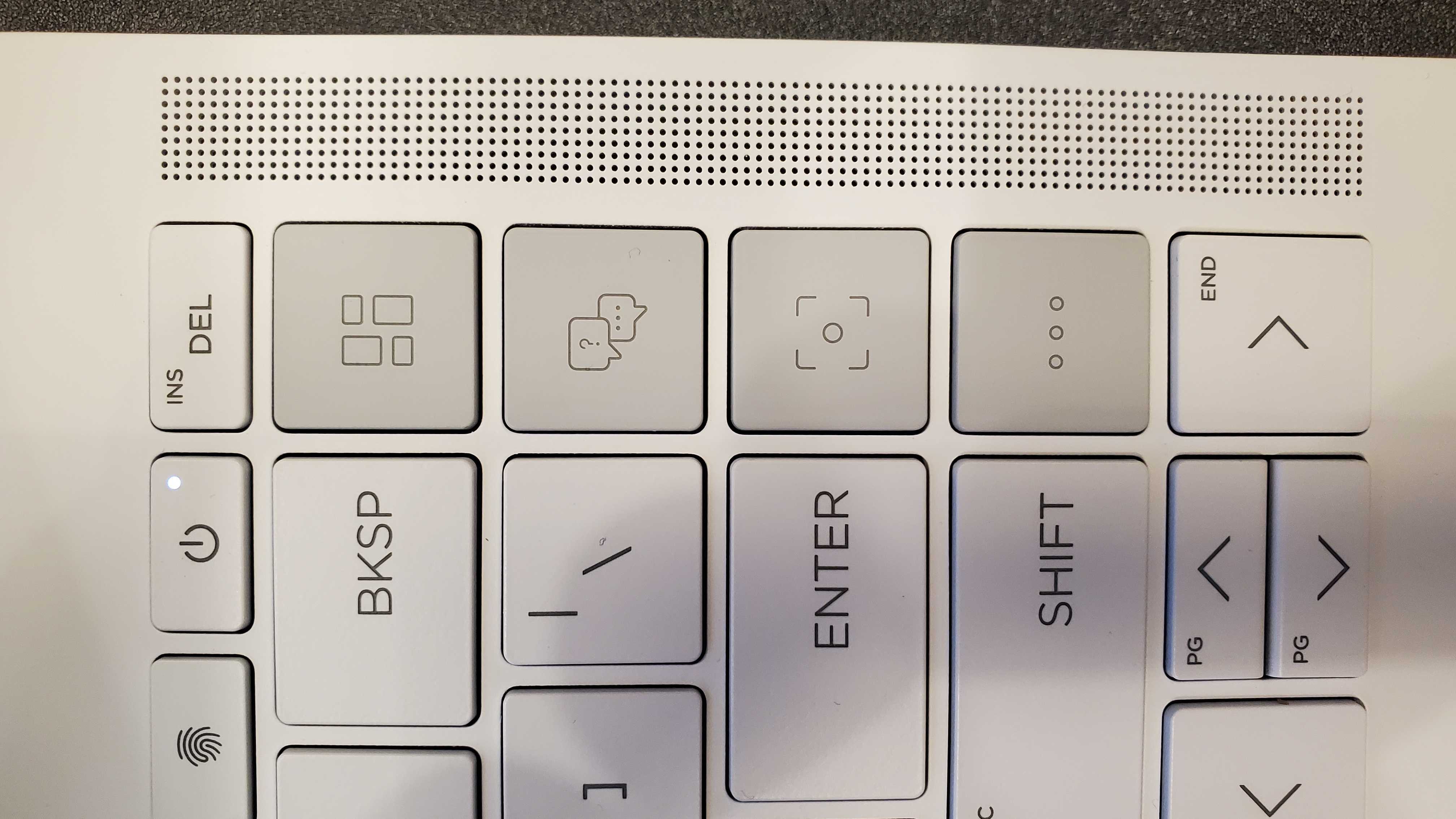a white laptop opened, closeup of several keys